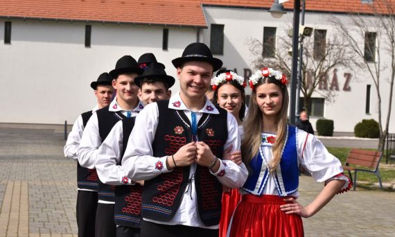 A group of young adults in traditional Hungarian folk costumes in Máriapócs, Hungary.